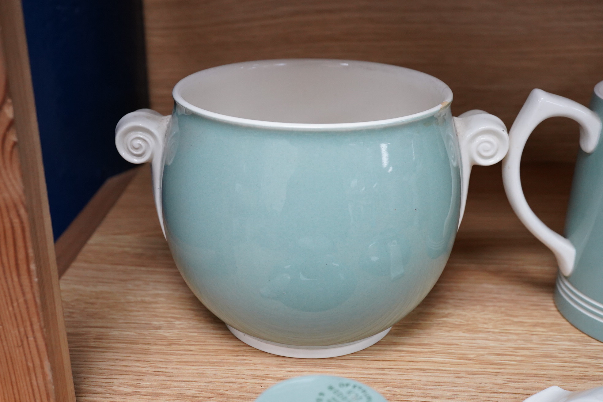 Keith Murray for Wedgwood - a celadon mug, two handled vase and two tazzas, tallest 13cm